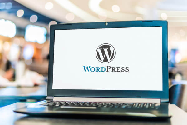 A laptop computer screen with a WordPress logo