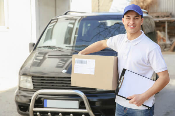 A delivery messenger is holding a package