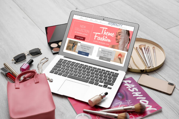 A beauty fashion store theme showcased on a laptop