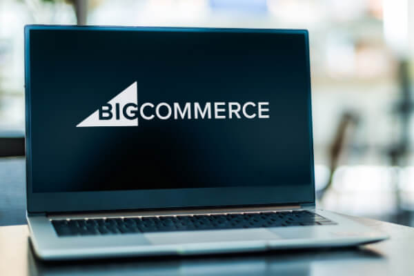 A laptop screen is showing BigCommerce logo