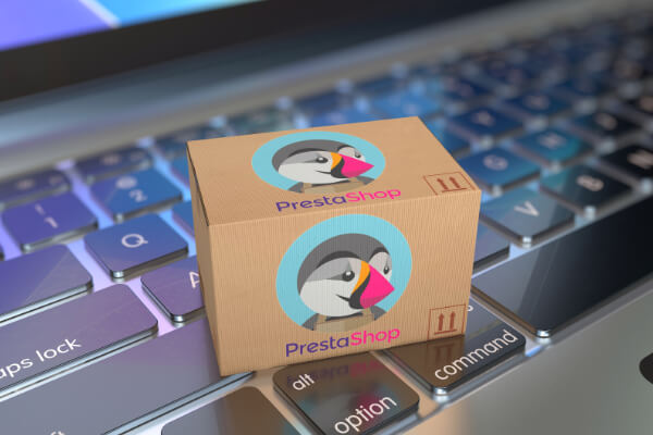 A package with Prestashop's logo on a laptop keyboard