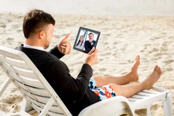 A remote professional in a virtual meeting at the beach