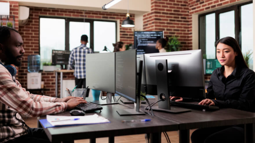 A website maintenance team of experts in front of their desks