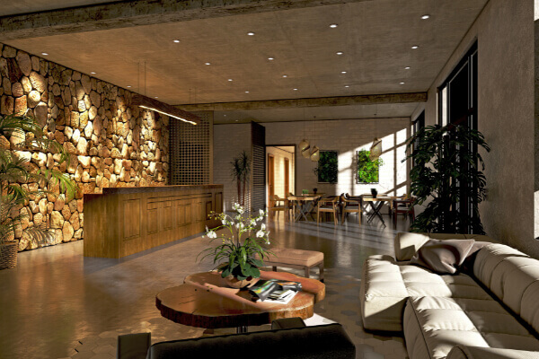 A modern hotel lobby with a rustic, stacked stone feature wall behind a wooden reception desk, complemented by contemporary furniture, natural wood coffee tables, and indoor plants.
