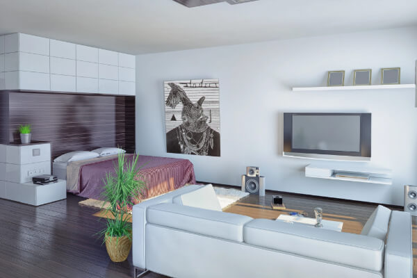 A wide-angle, hyper-realistic, and brightly lit image of a modern, open-concept studio apartment. The living area features a white sofa facing a television mounted on a wall, and a bedroom area with a bed and a unique piece of artwork on the wall behind it. The space has dark hardwood floors and minimalist decor.