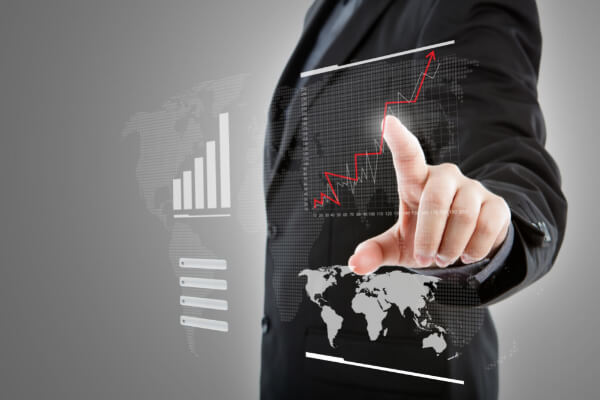 A professional pointing at a digital holographic world map with rising growth charts, representing international AI sales strategy.